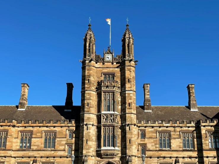 a large stone building with a clock tower and many windows