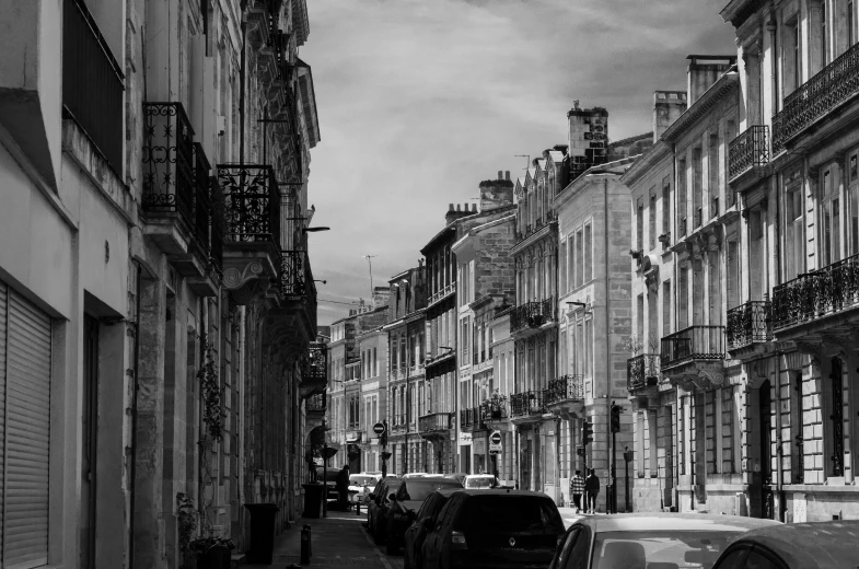 a road with many cars parked in front of buildings