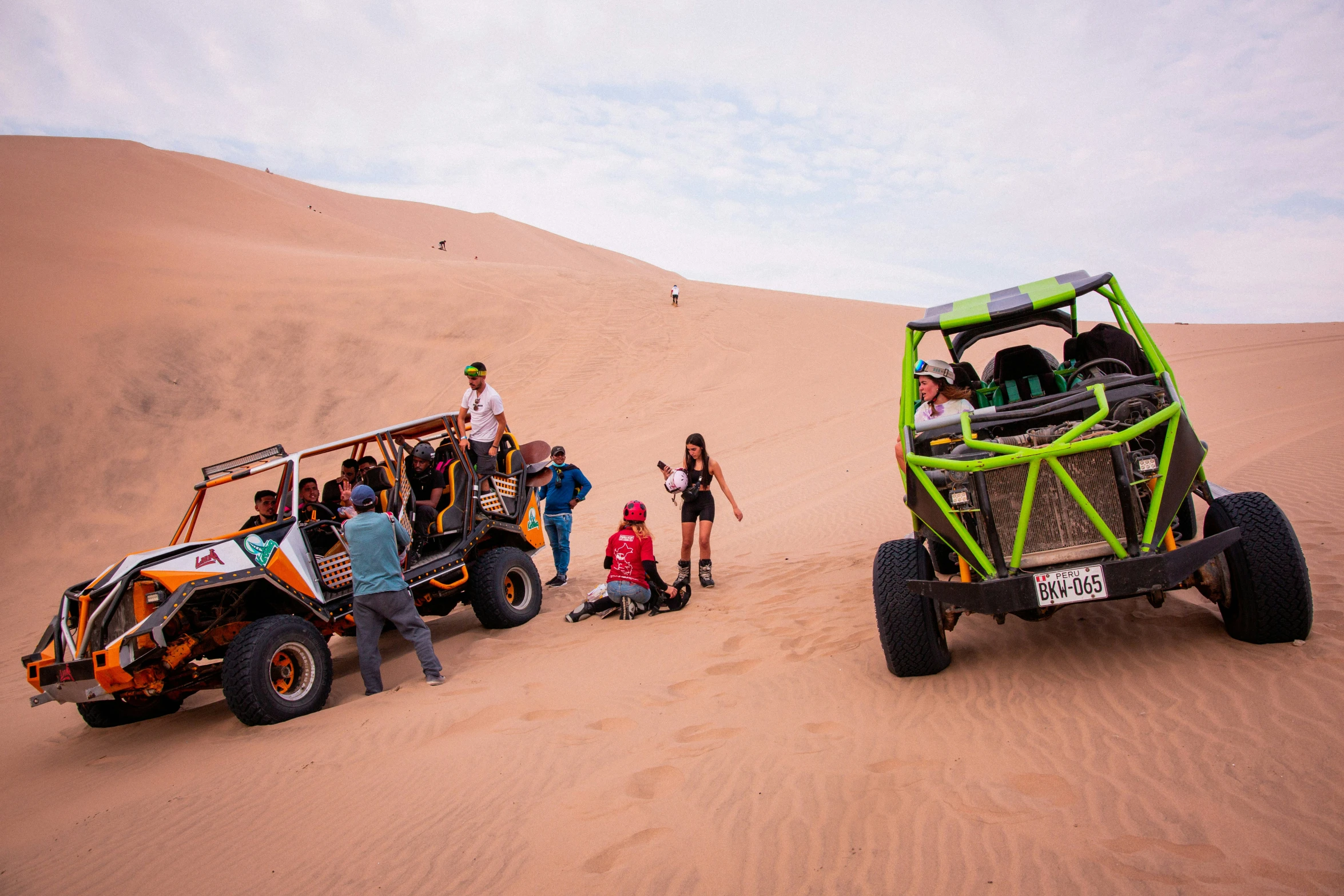 four people and a jeep with a roof full of mud