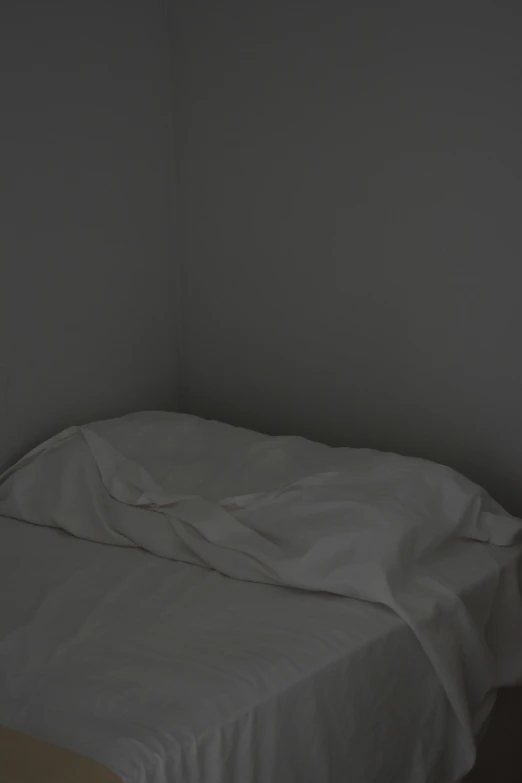 an empty bed in a small room
