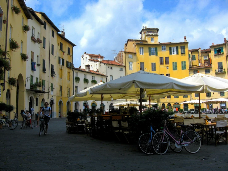 bikes parked near outdoor seating and tables in a small town square
