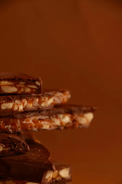 chocolate and almond covered cookies are stacked on top of each other