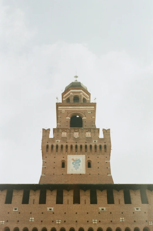 tall clock tower at the top of a brick building