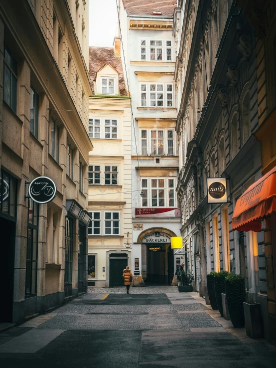 a narrow alley between old buildings in a city