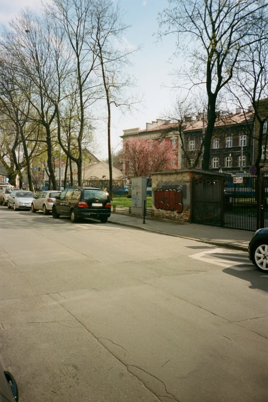 a city street is lined with parked cars