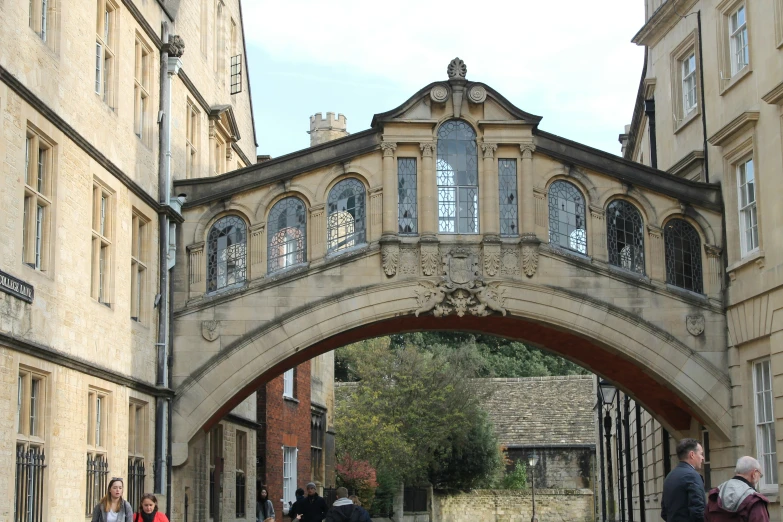 a bridge crosses over a small narrow street