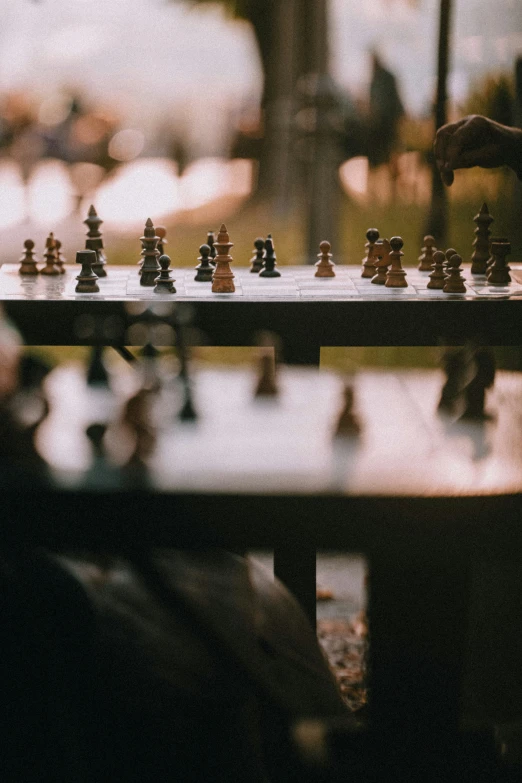 a man setting up a chess board with various pieces on it