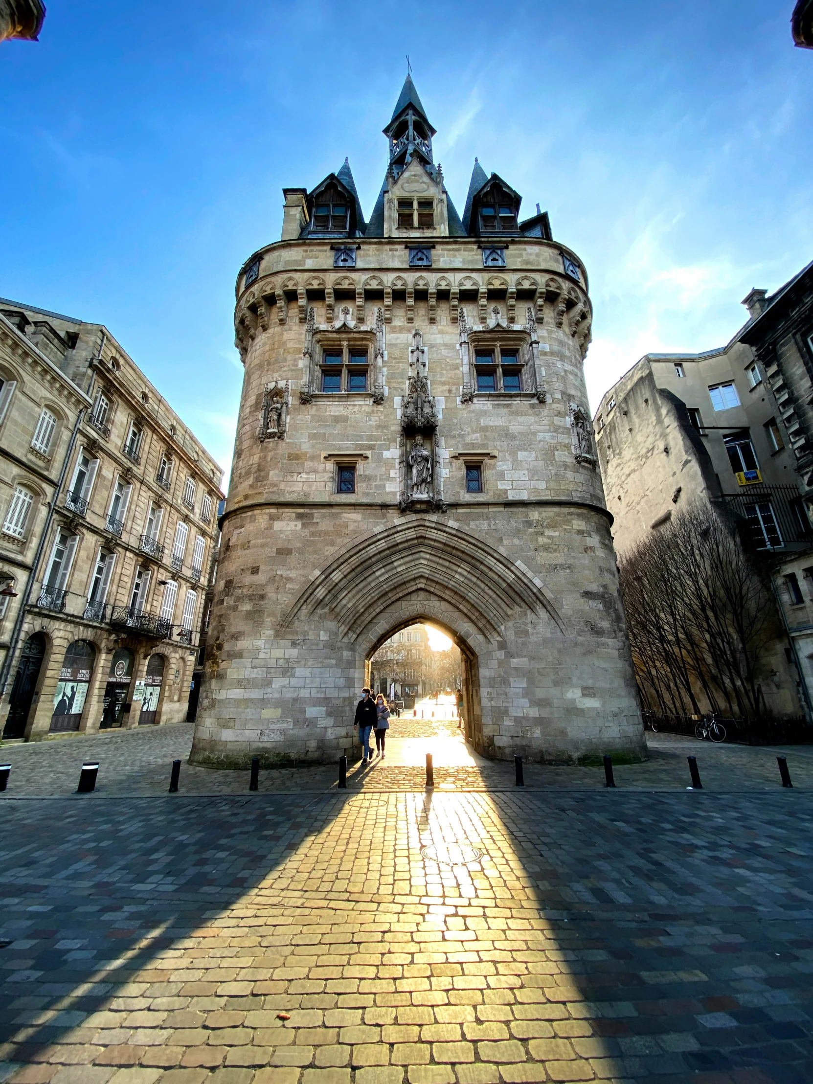 a long walkway leading to a tall clock tower