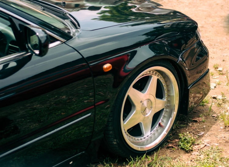 a car parked in a field near some grass