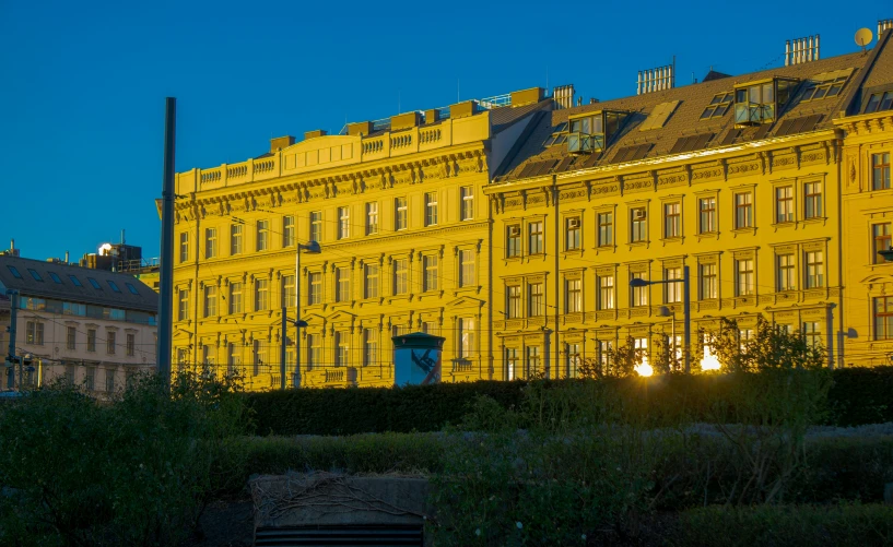 an image of some old buildings in the sunset