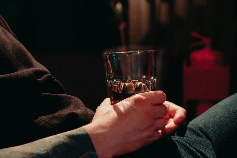 a person holding a drink with their hands