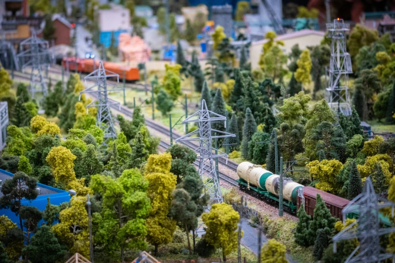 the trains are moving down the tracks in the woods