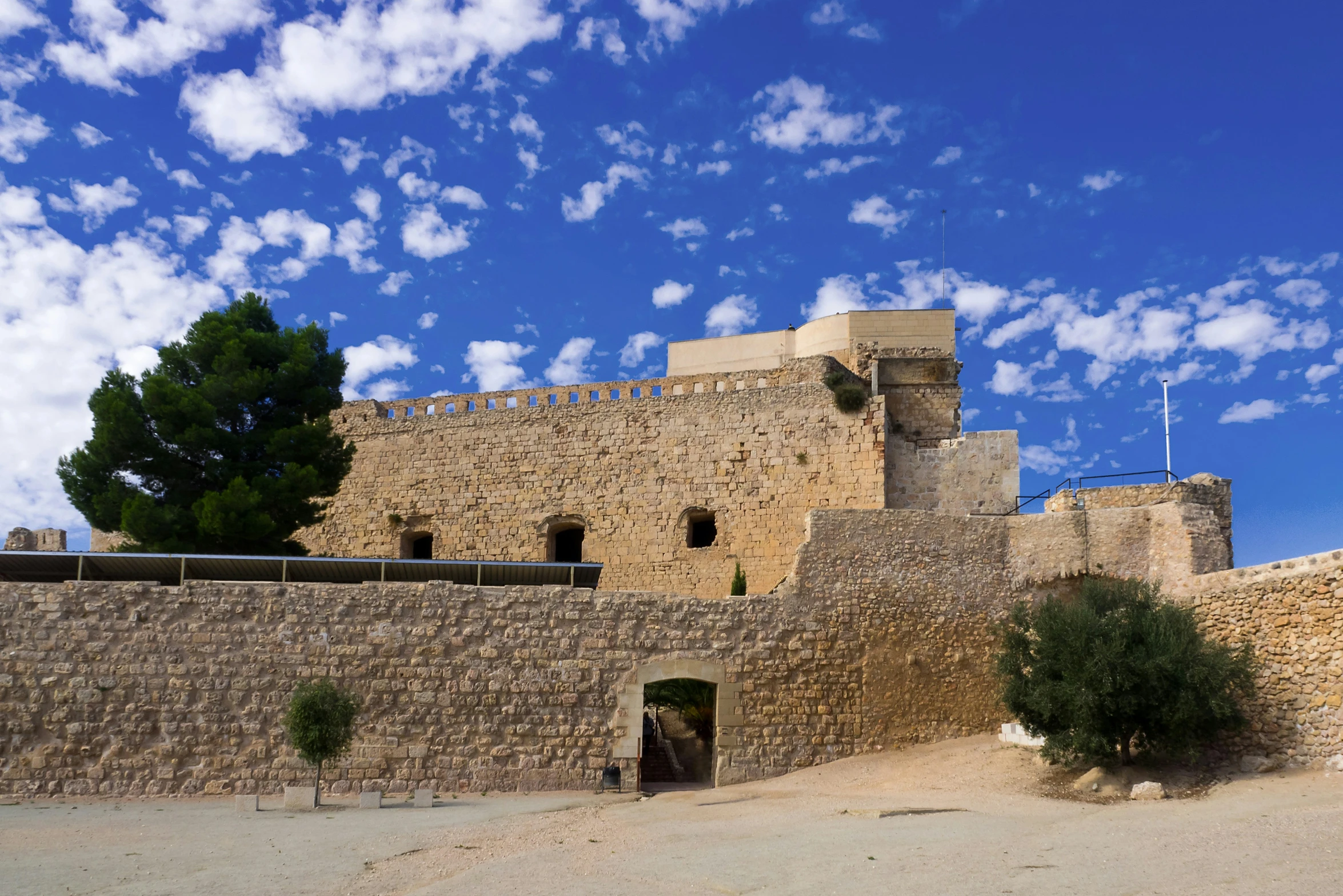 the castle of a very large medieval structure is very tall and it looks majestic