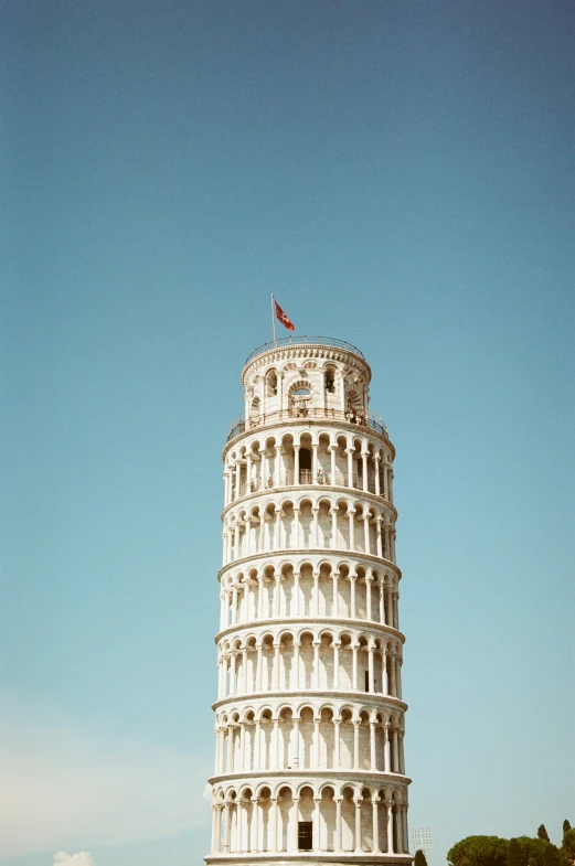 a large white building has a flag on top