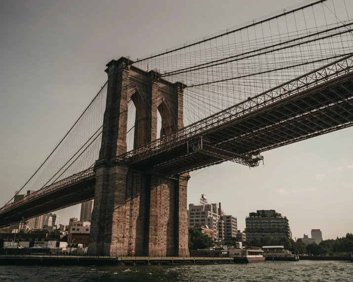 the brooklyn bridge rises above the cityscape