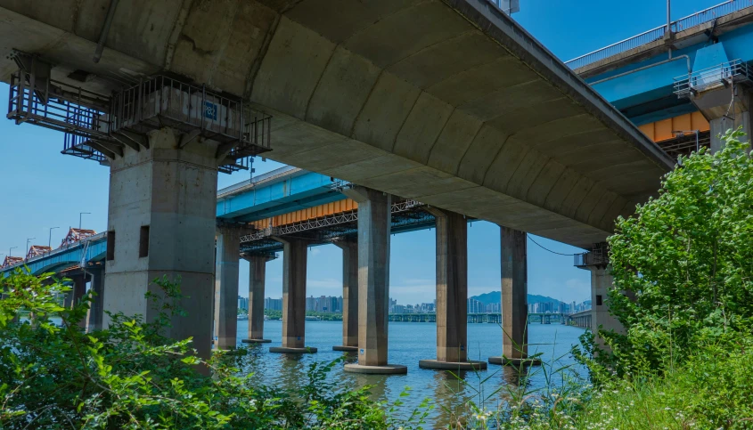 the underside of a bridge over water under it