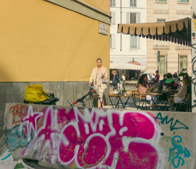 a man stands next to a ramp covered in grafitti