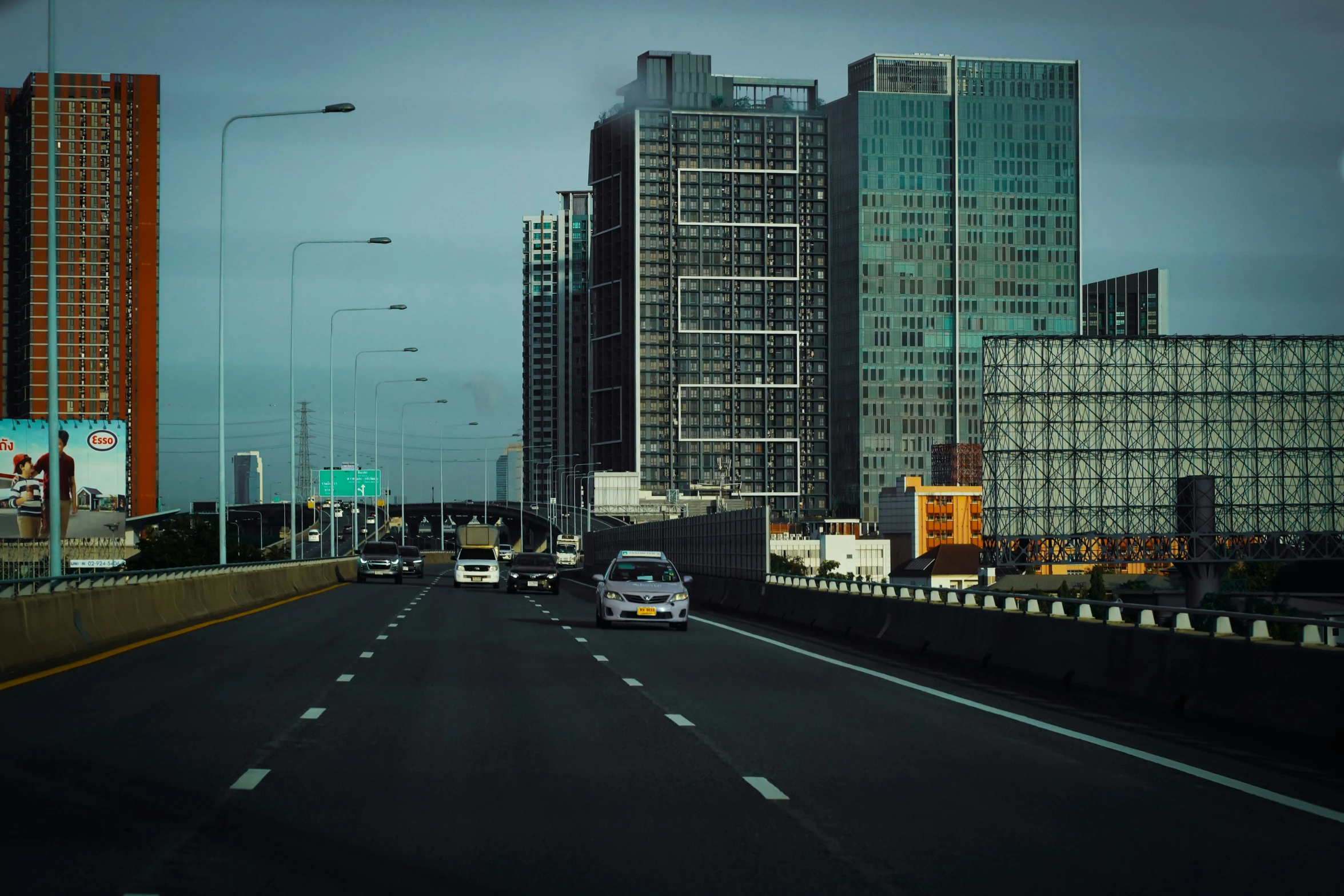 a city street is lined with tall skyscrs