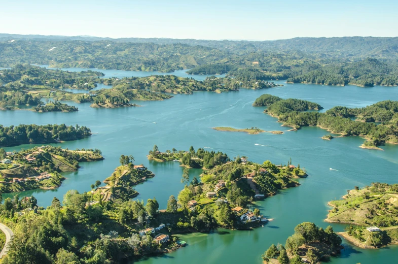 an aerial view of a lake surrounded by forest