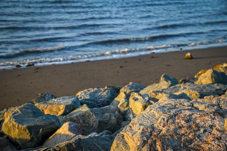 there is soing yellow and blue that can be seen from rocks on the beach