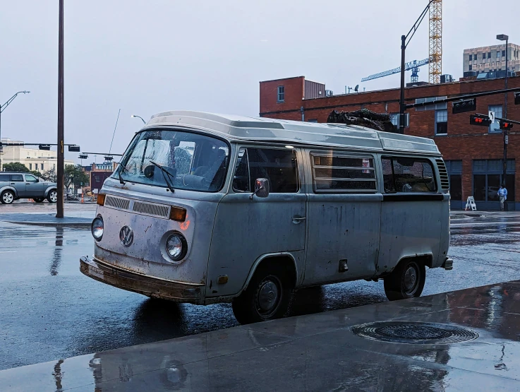 an old van is parked in front of the street