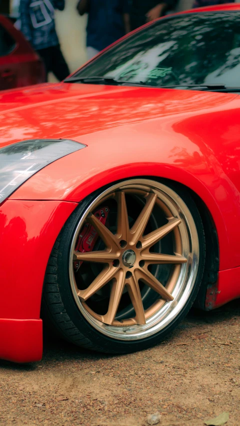 a red sports car with yellow rims and gold wheels