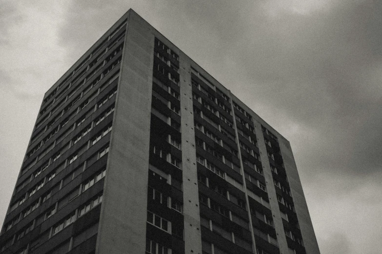 an old tall building sits against a cloudy sky