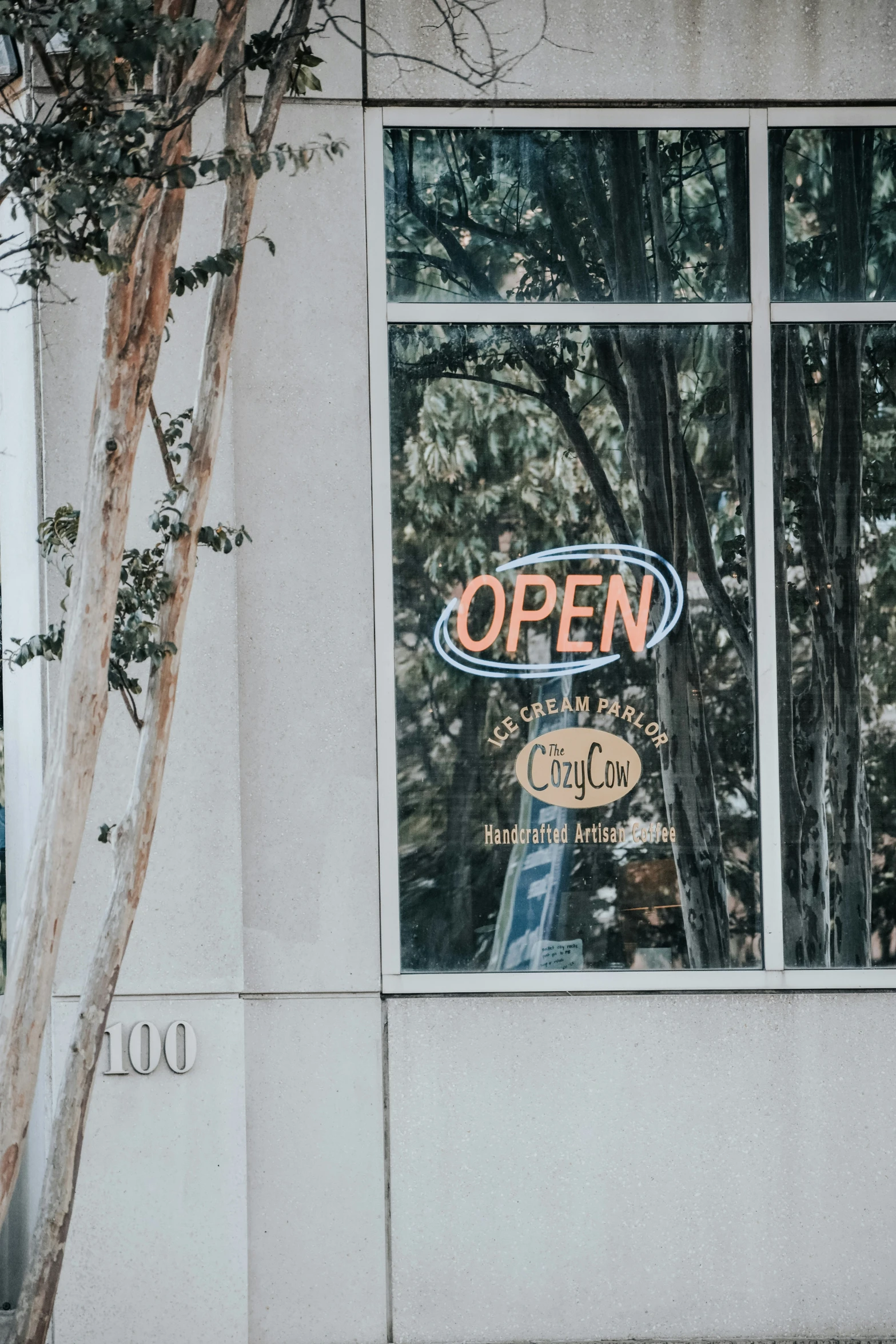 an open sign is hung in the window