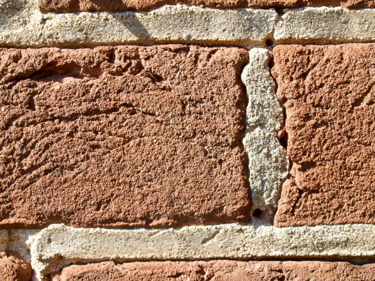 the stone wall is covered in tiny holes