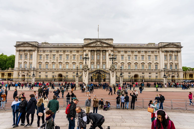 many people outside of a large building