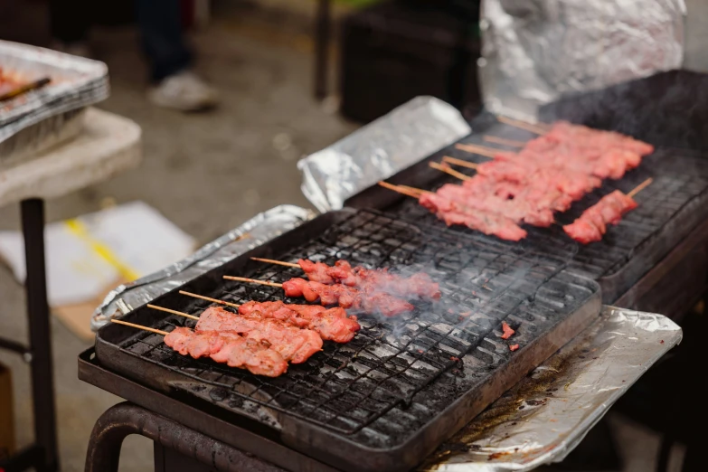 a bunch of food is being grilled on a grill