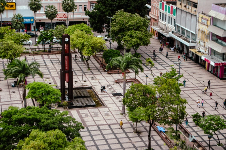 some people walk around a square in front of shops