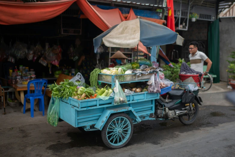 a man that is sitting behind a cart