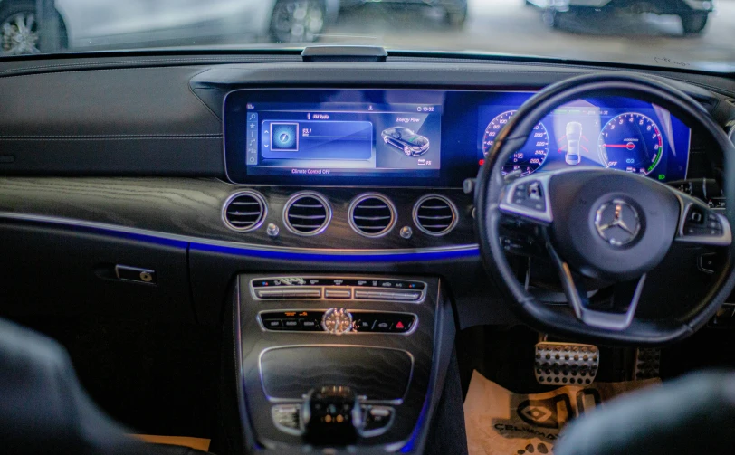 a mercedes car dashboard with a blue and black dash light