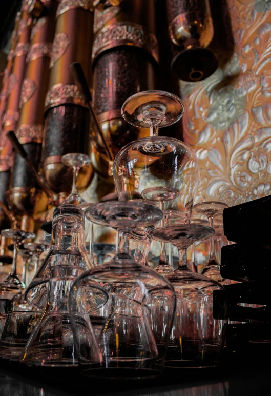 a bunch of glasses are stacked near some books