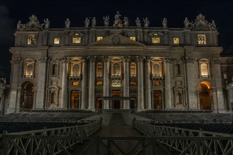 an ornate building lit up at night with a clock