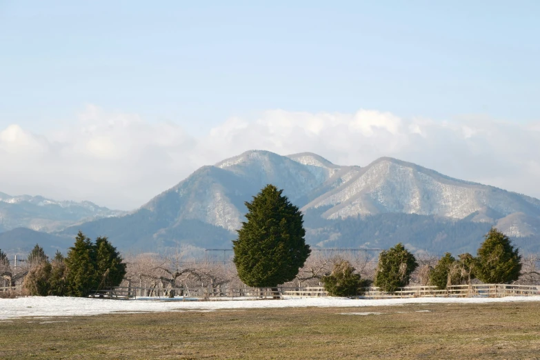 the mountains can be seen in the distance as snow covers them