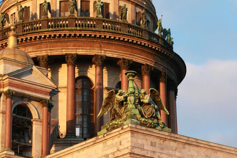 a statue is placed on the top of a domed building