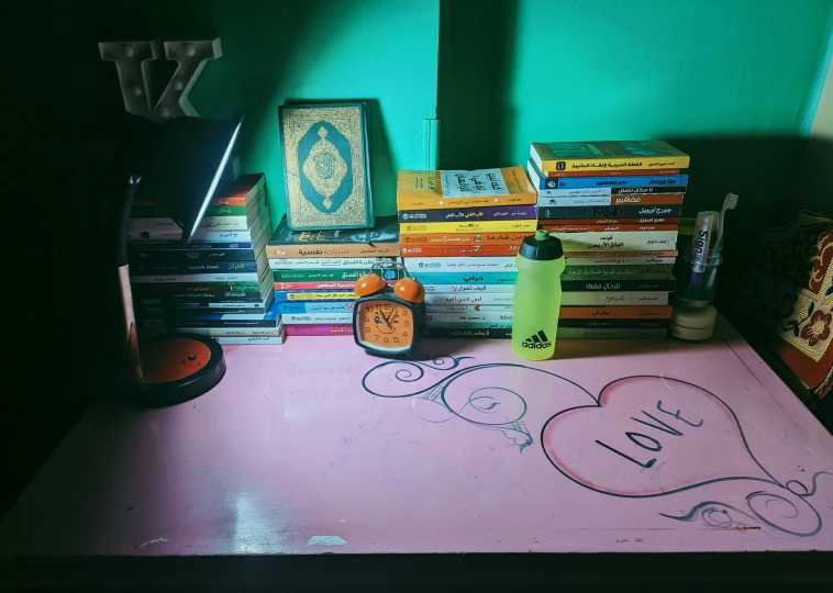 a desk covered with books and a couple of pictures