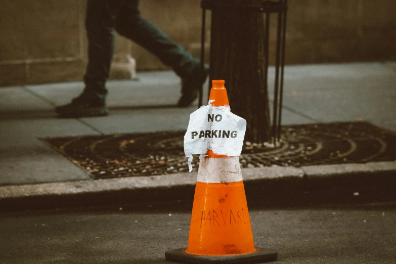 a traffic cone is placed next to a trash can