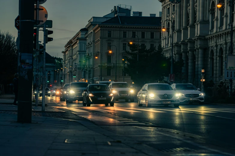 many cars drive down the busy road on a rainy night