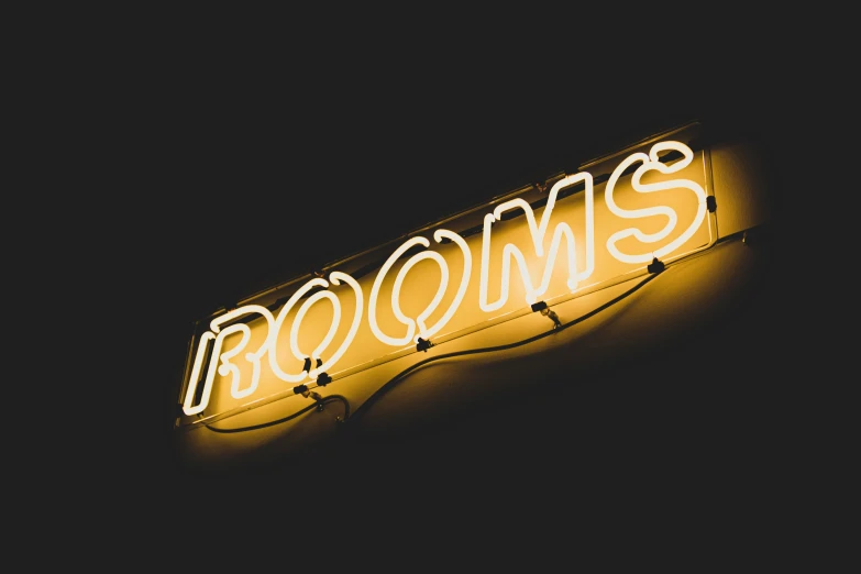 neon sign above a room entrance with the name browns