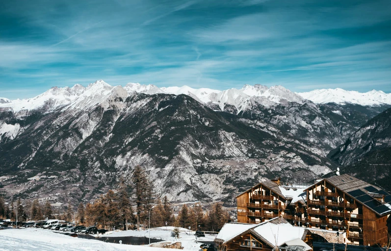 a resort with a snowy mountain in the background