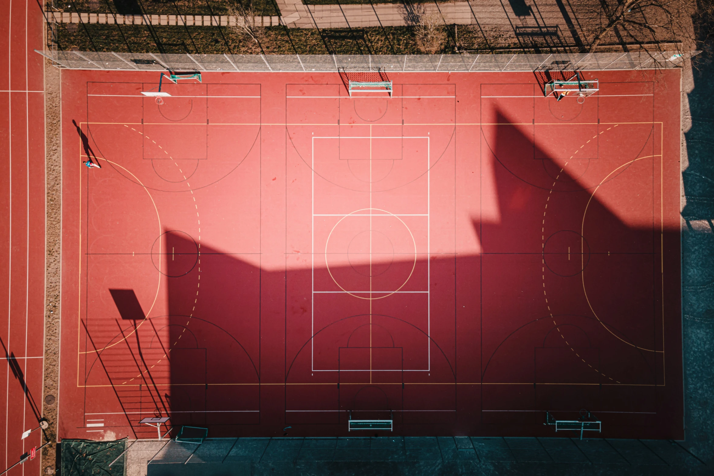 an aerial view of a basketball court with benches