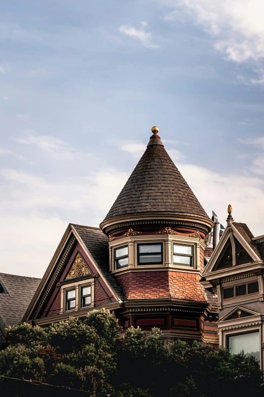 a tall victorian house with a pointy roof