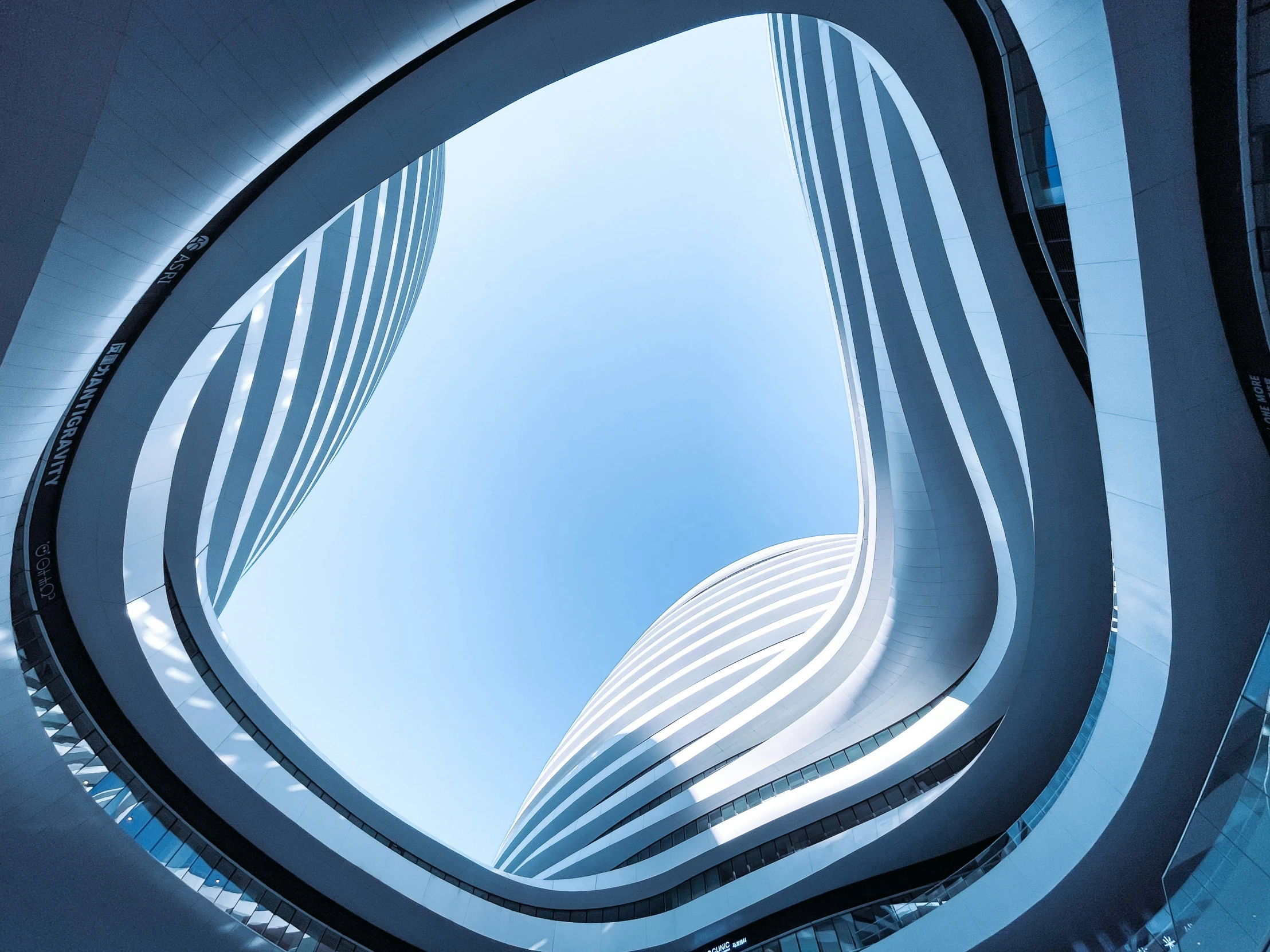 the view from a circular window looking up at a building