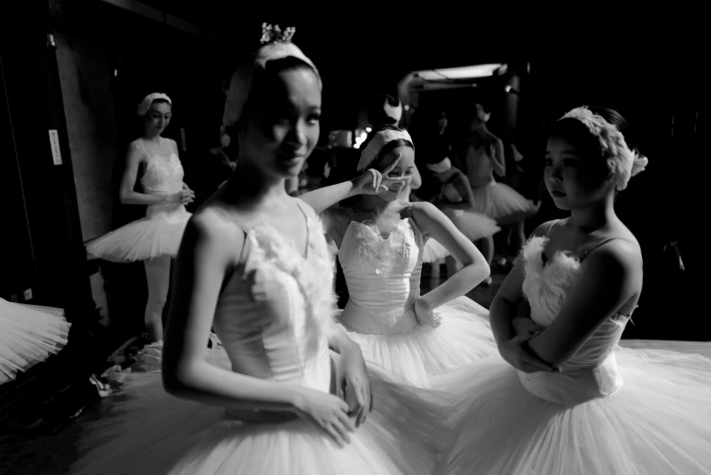 some girls in tulle skirts are posing for the camera