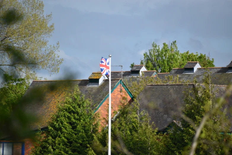 a small flag is flying on a house's roof