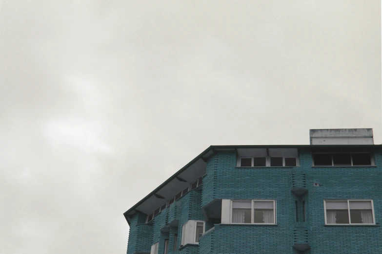 some blue building and the tops of three windows