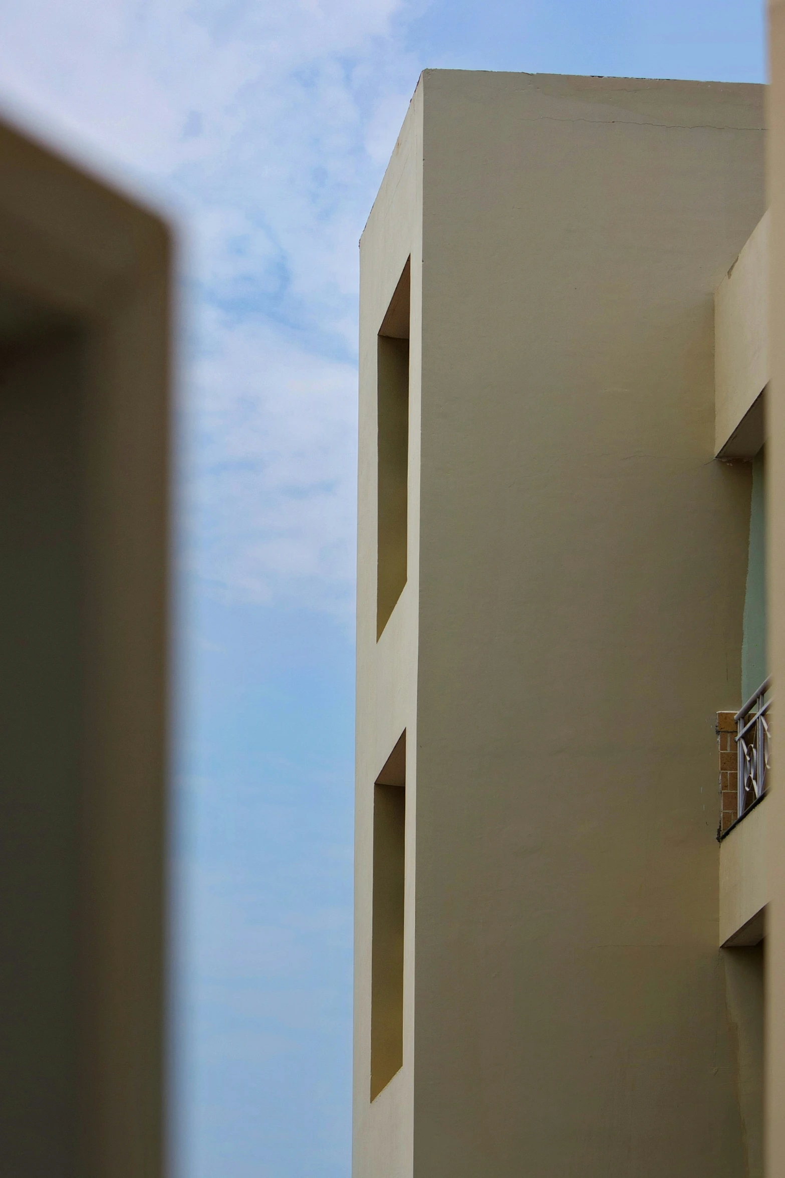 an apartment building with the sky in the background